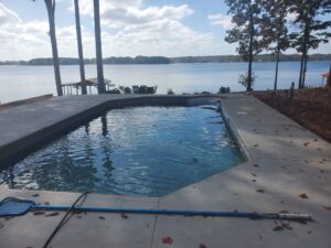 a gorgeous asymmetrical inground pool installed by Kirk's Pool and Hearth