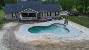 a vinyl pool with a custom shape and design, freshly installed by Kirk's Pool and Hearth