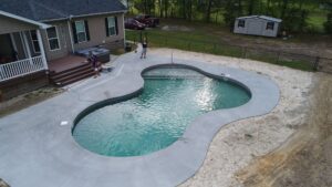 an asymmetrical vinyl pool installed by Kirk's Pool and Hearth