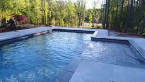 a fiberglass pool with a custom design crafted by Kirk's Pool and Hearth