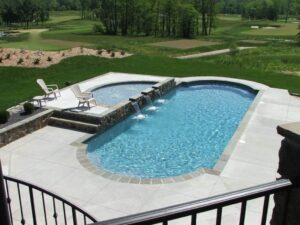 a beautiful fiberglass pool from Kirk's Pool and Hearth shimmering in the afternoon sun